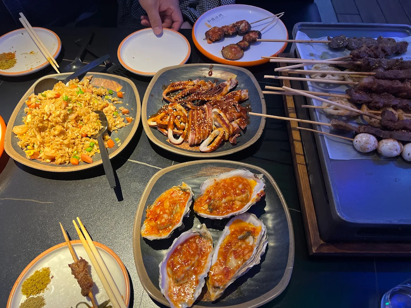 Fried rice, squid, oysters and skewers at Xinjiang BBQ, a Barbecue Restaurant in San Diego