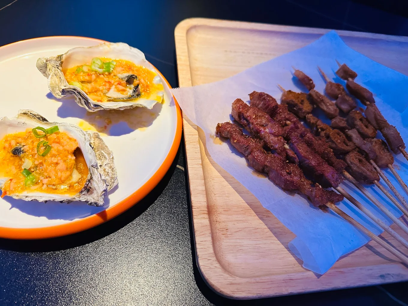Garlic oysters and beef skewers at Xinjiang BBQ, a Barbecue Restaurant in San Diego